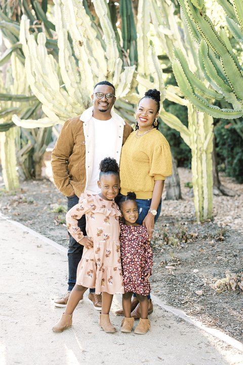 Family standing in front of tall cacti in Beverly Hills